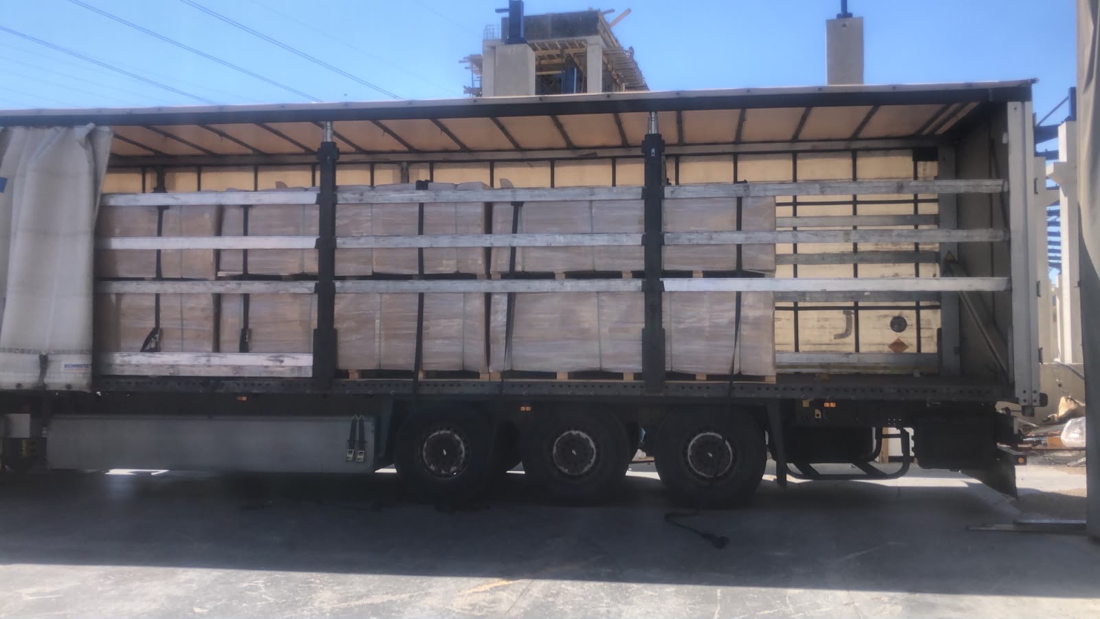 Tautliner truck loaded with wrapped pallets of SONAVEER acoustic wall panels ready for wholesale delivery